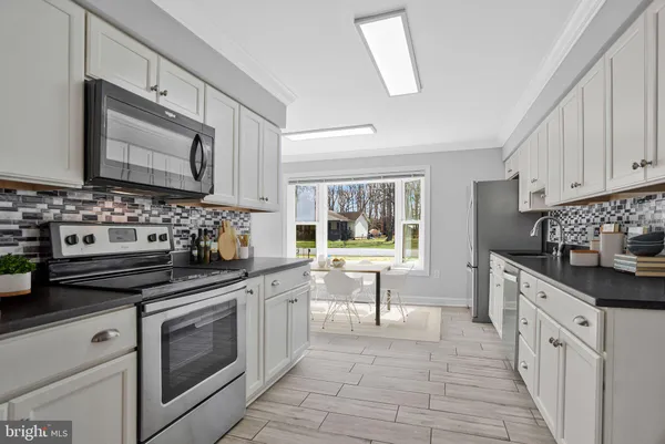 a kitchen with stainless steel appliances a stove sink and cabinets