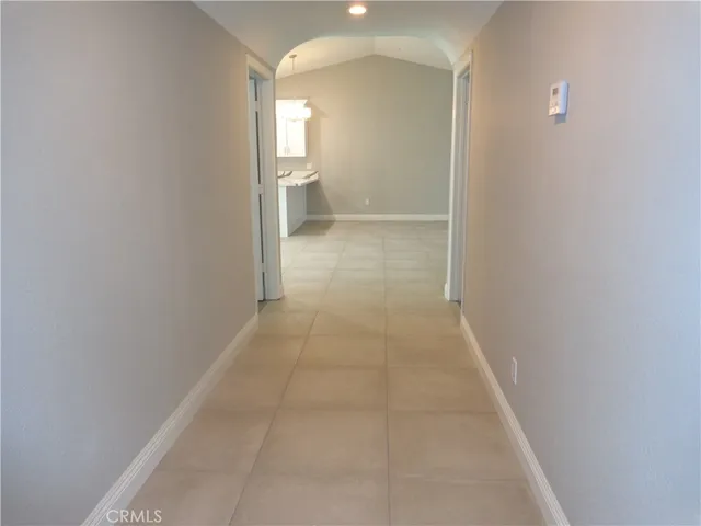 a view of a room with an empty space and window