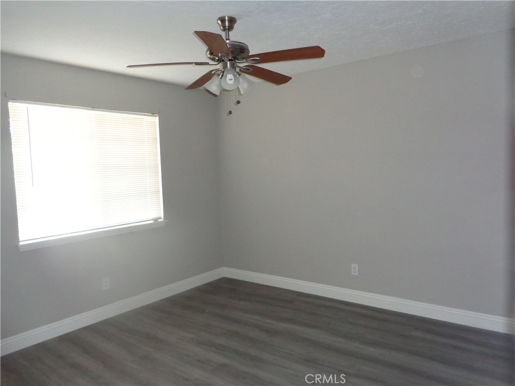 12744 Running Deer Road Apple Valley, CA 92308 - Photo 18 of 30 a view of a big room with wooden floor closet and windows
