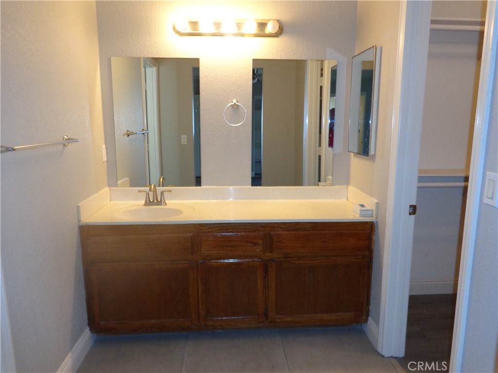 12744 Running Deer Road Apple Valley, CA 92308 - Photo 21 of 30 a bathroom with a sink and a mirror