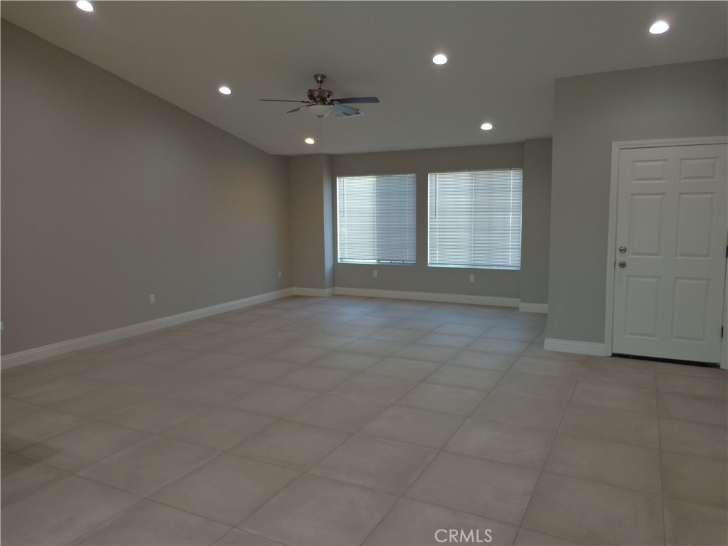 12744 Running Deer Road Apple Valley, CA 92308 - Photo 3 of 30 a view of an empty room with a window