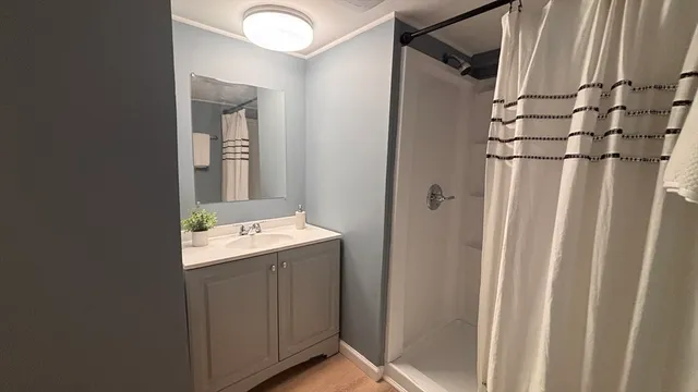 a bathroom with a granite countertop sink and mirror