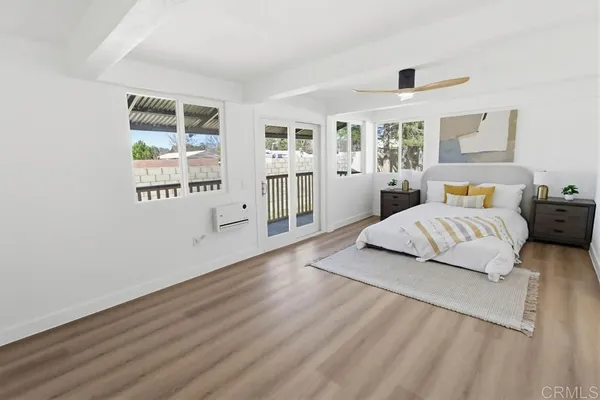a bedroom with a large bed and a window