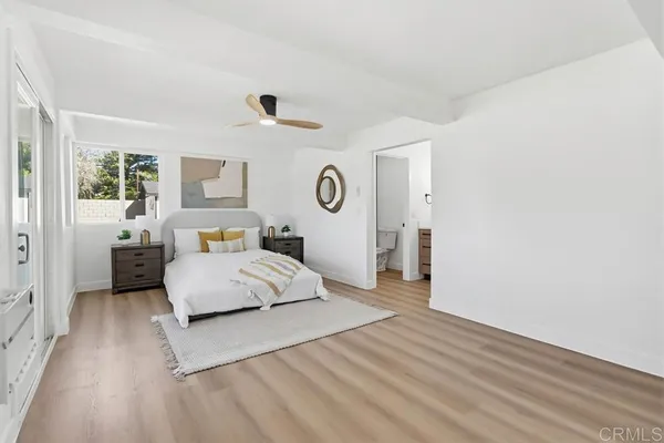 a spacious bedroom with a bed and a couch