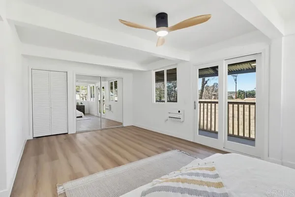 a bedroom with a large bed and a window