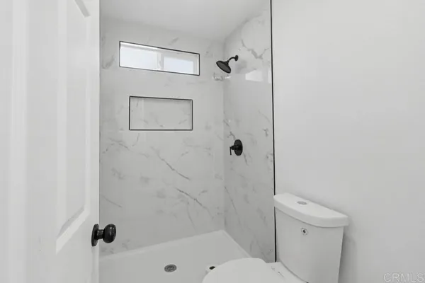 a bathroom with a shower and a toilet