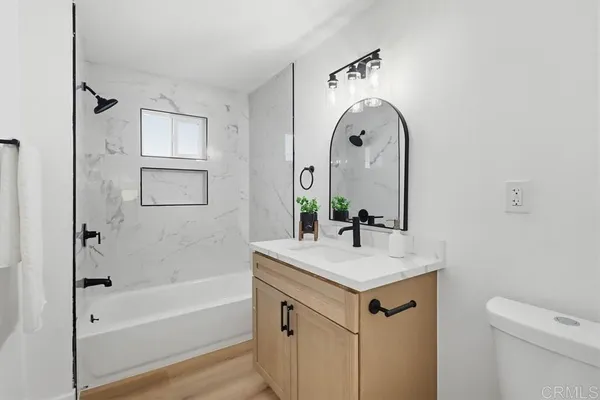 a bathroom with a sink a mirror and a bathtub