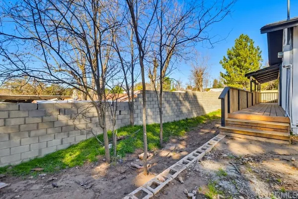 a view of a house with wooden fence