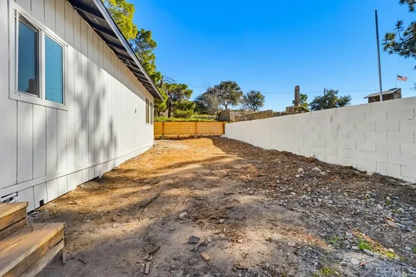 a view of yard with tree in front of it
