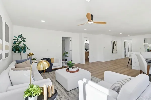 a living room with furniture and wooden floor