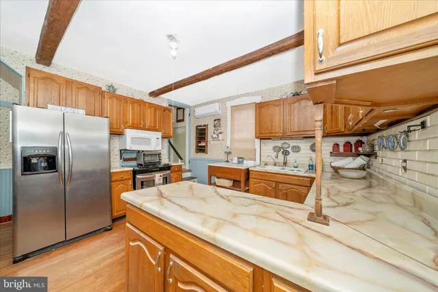a kitchen with a stove a sink and a microwave