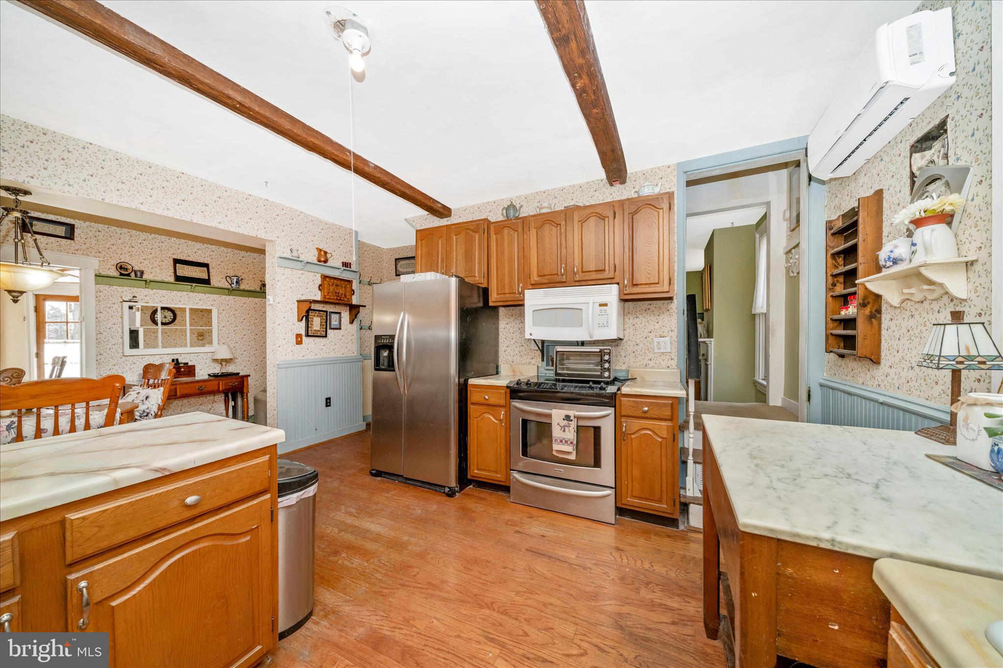6710 Ford Road Frederick, MD 21702 - Photo 17 of 62 a kitchen with stainless steel appliances granite countertop a refrigerator a stove and a sink with couches
