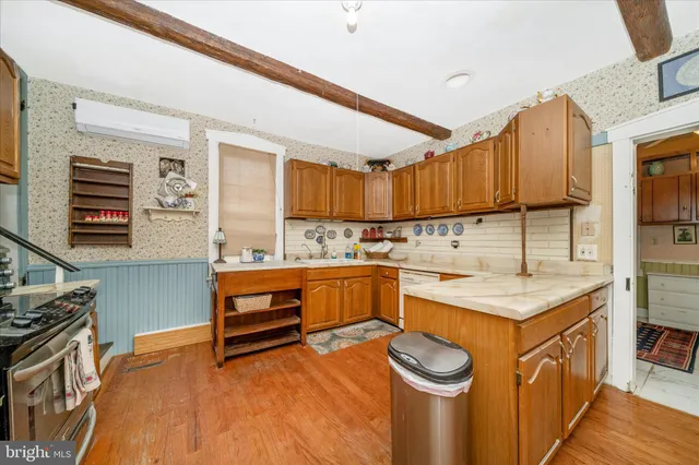 a dining room with furniture a chandelier and wooden floor