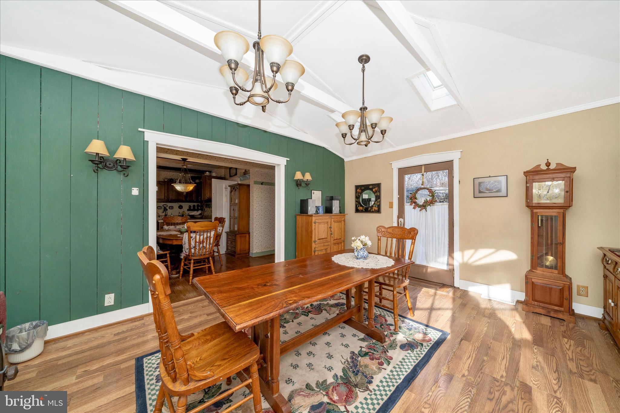 6710 Ford Road Frederick, MD 21702 - Photo 24 of 62 a dining room with wooden floor a chandelier a wooden table and chairs