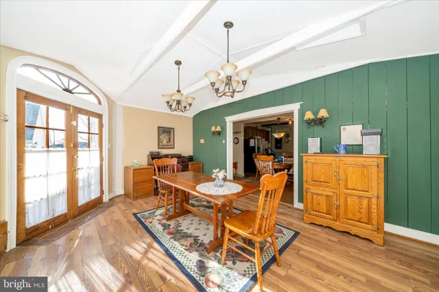 a spacious bedroom with a bed and a chandelier