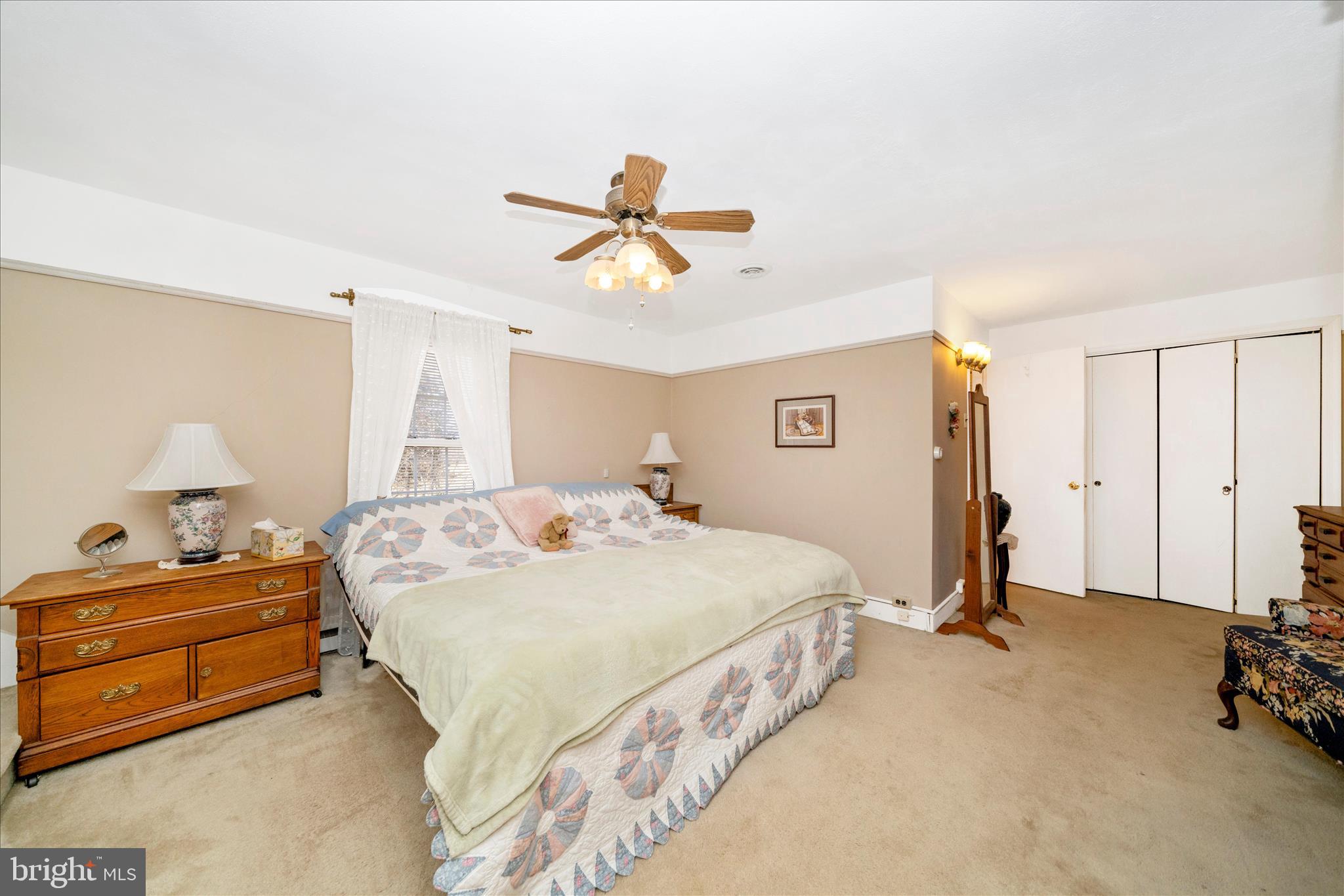 6710 Ford Road Frederick, MD 21702 - Photo 30 of 62 a spacious bedroom with a bed and a chandelier