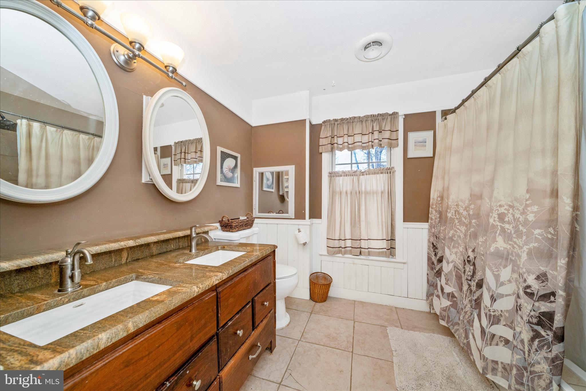 6710 Ford Road Frederick, MD 21702 - Photo 34 of 62 a bathroom with a double vanity sink a mirror and a bathtub