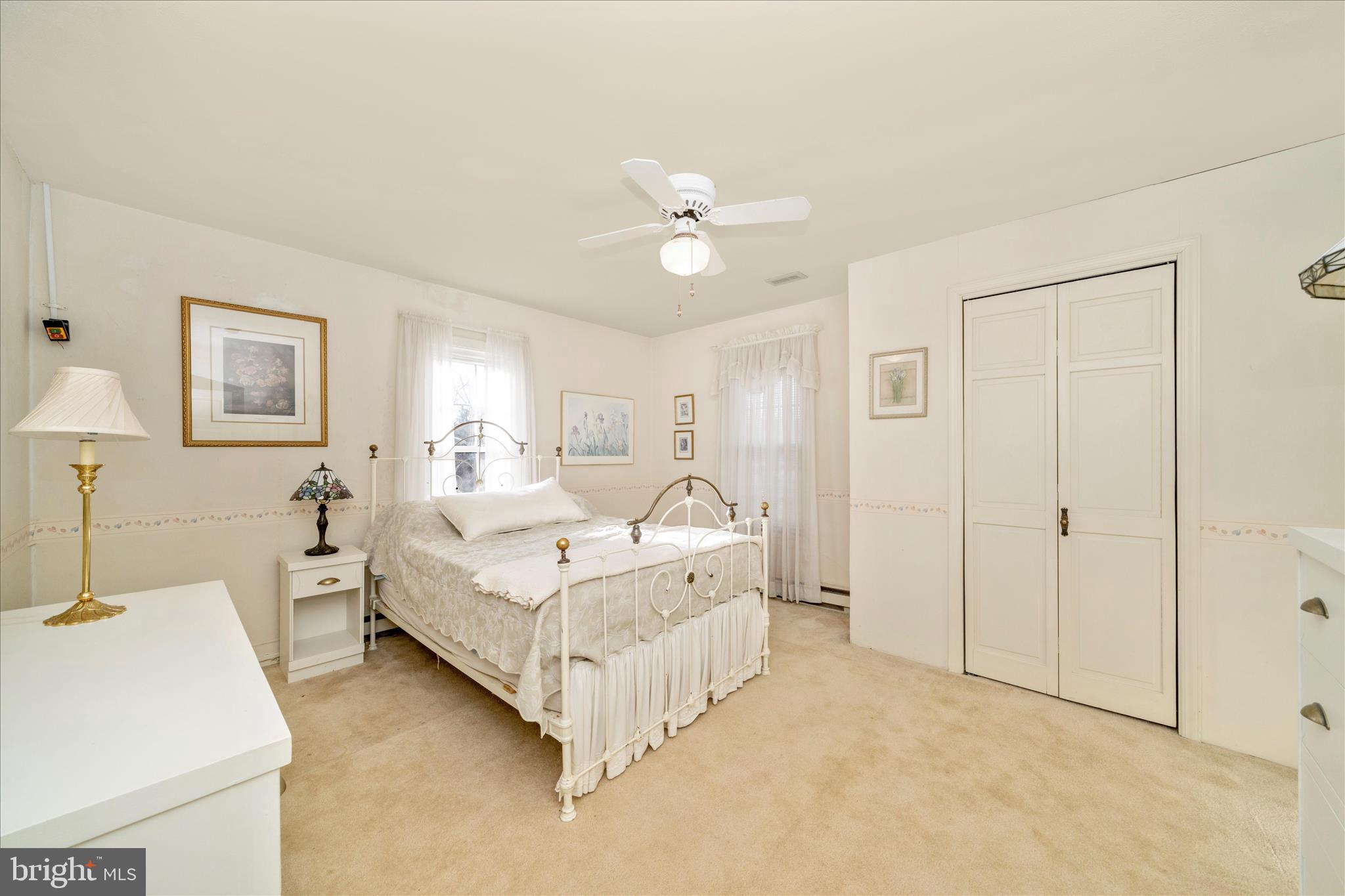 6710 Ford Road Frederick, MD 21702 - Photo 37 of 62 a spacious bedroom with a bed and a chandelier