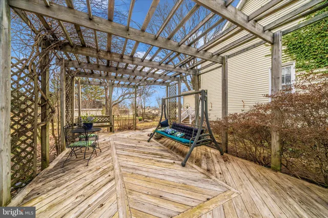 a view of a patio with couches and chairs with wooden floor