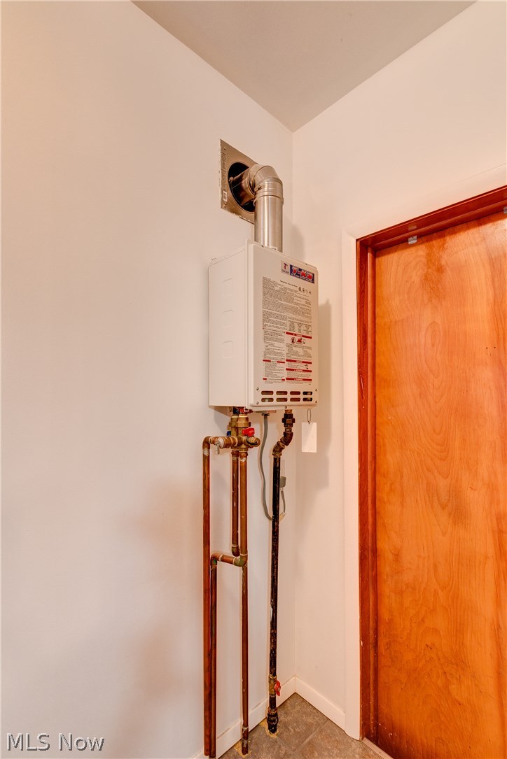 39022 Johnnycake Ridge Road Willoughby, OH 44094 - Photo 19 of 22 Tankless water heater set up and access to attached garage from 1st floor laundry room