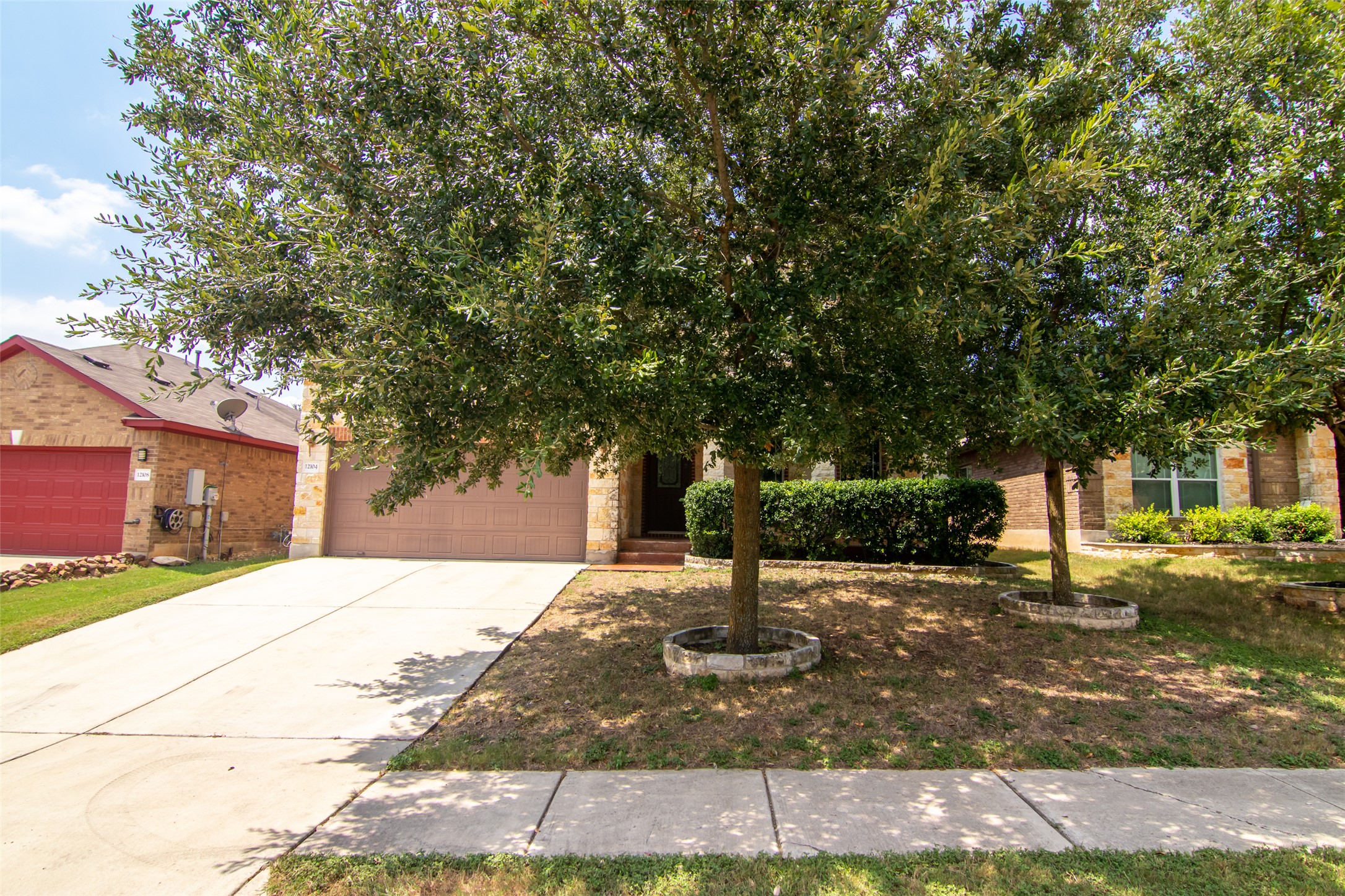 12104 Broten Street Austin, TX 78748 - Photo 2 of 32 Mature trees and neat landscaping frame this inviting home, offering charming curb appeal.