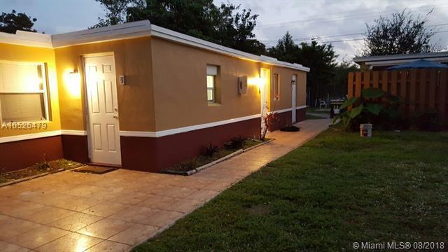 5856 Garfield Street, Unit 2 Hollywood, FL 33021 - Photo 1 of 11 a view of backyard with trampoline