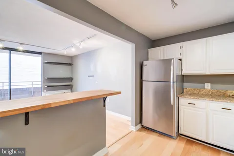 a kitchen with stainless steel appliances a refrigerator and a stove top oven