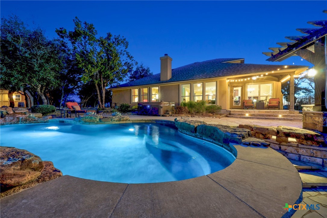 a view of a swimming pool with an outdoor seating