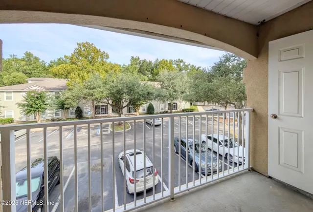 a view of a balcony with wooden fence