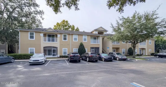 a front view of a house with cars parked
