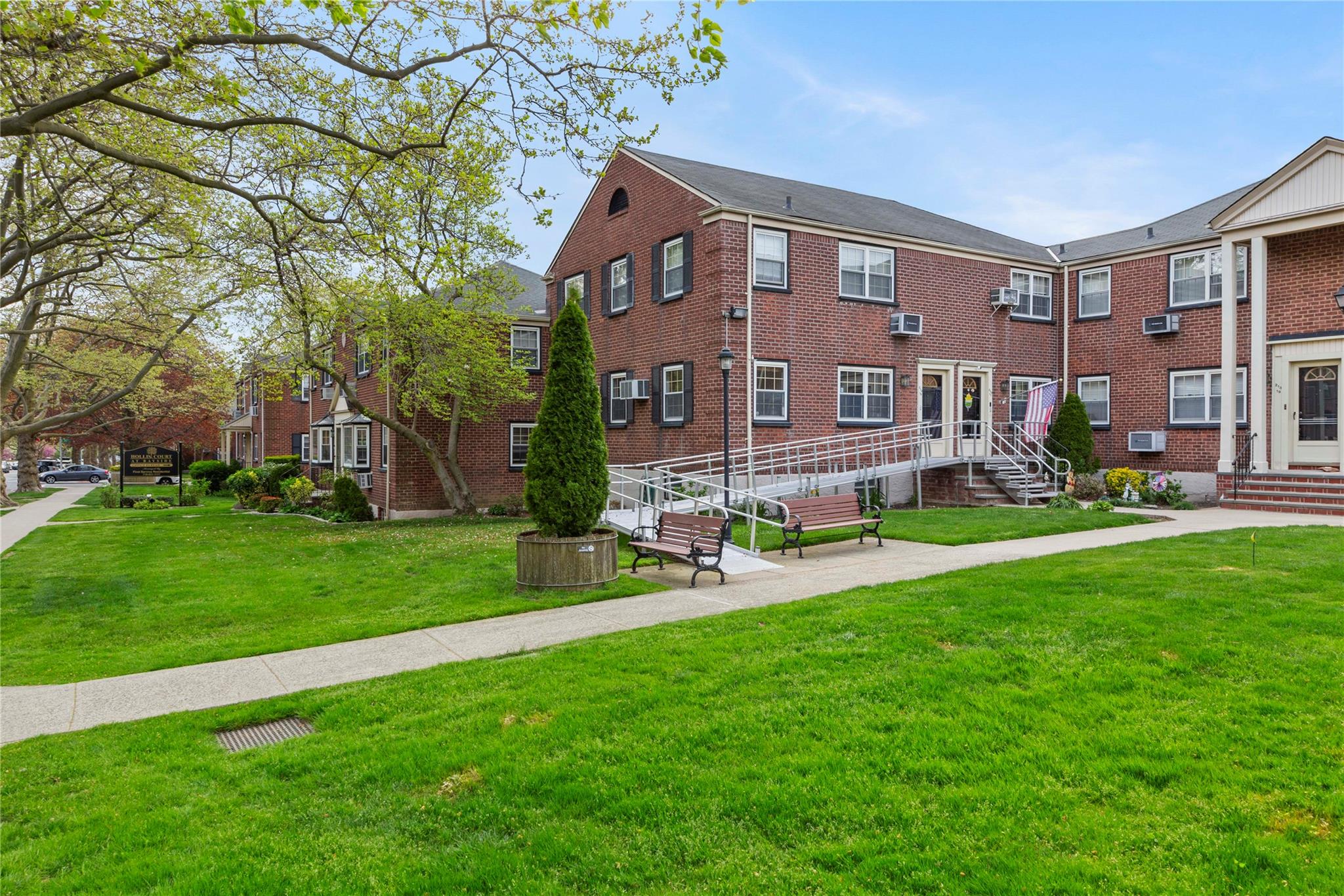 213-15 73rd Avenue, Unit LOWR Queens, NY 11364 - Photo 12 of 13 a front view of a building with a garden and plants