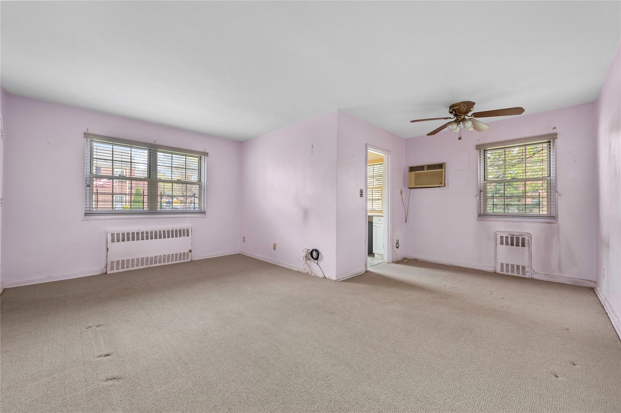 213-15 73rd Avenue, Unit LOWR Queens, NY 11364 - Photo 3 of 13 an empty room with windows and closet