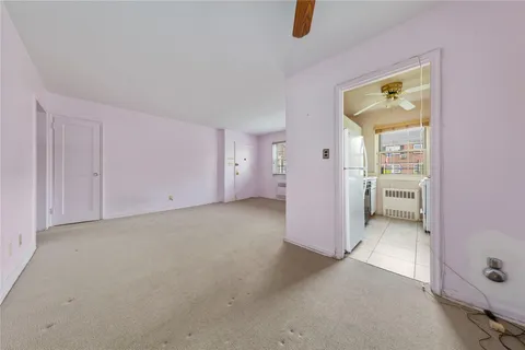 an empty room with closet and windows