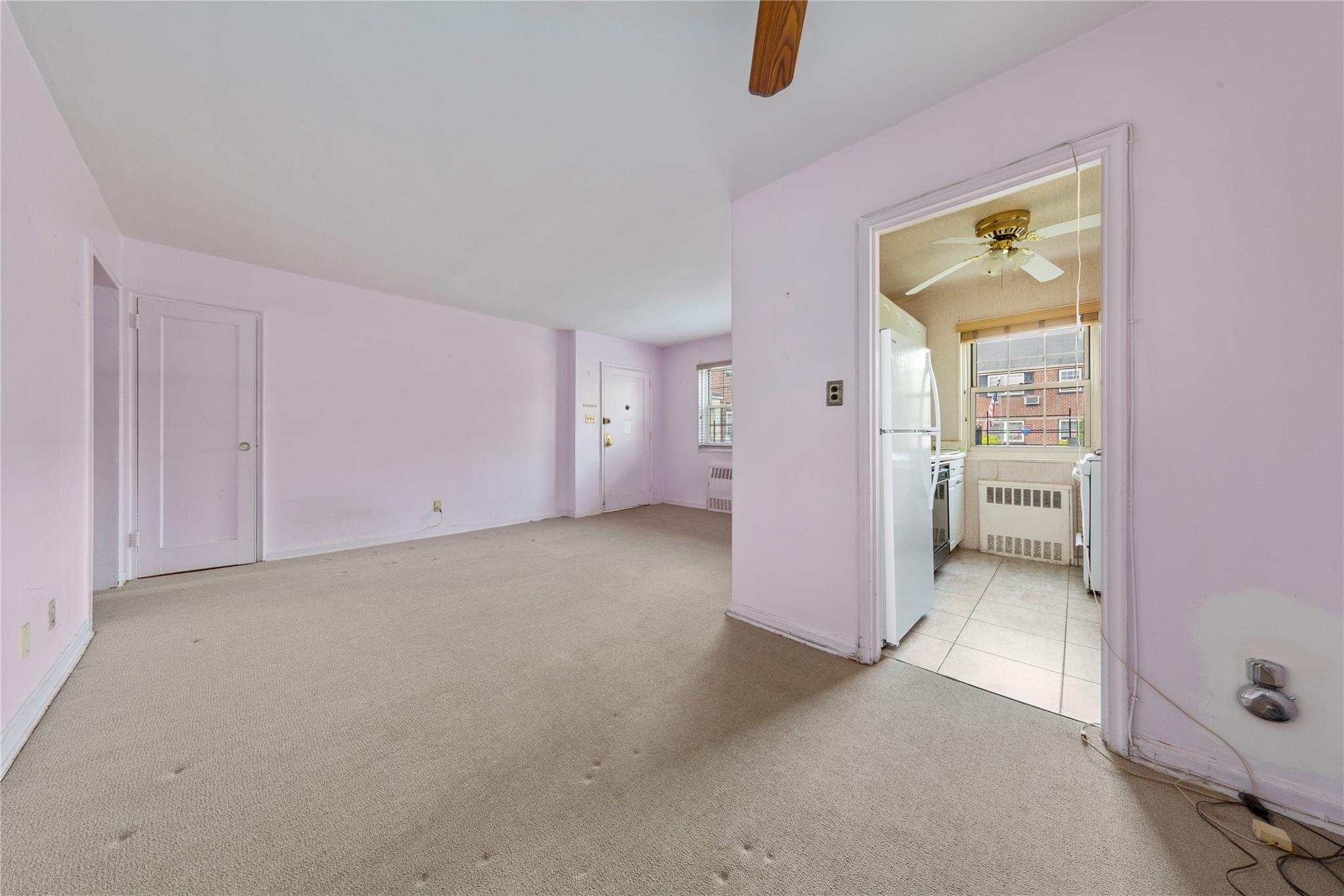 213-15 73rd Avenue, Unit LOWR Queens, NY 11364 - Photo 6 of 13 an empty room with closet and windows