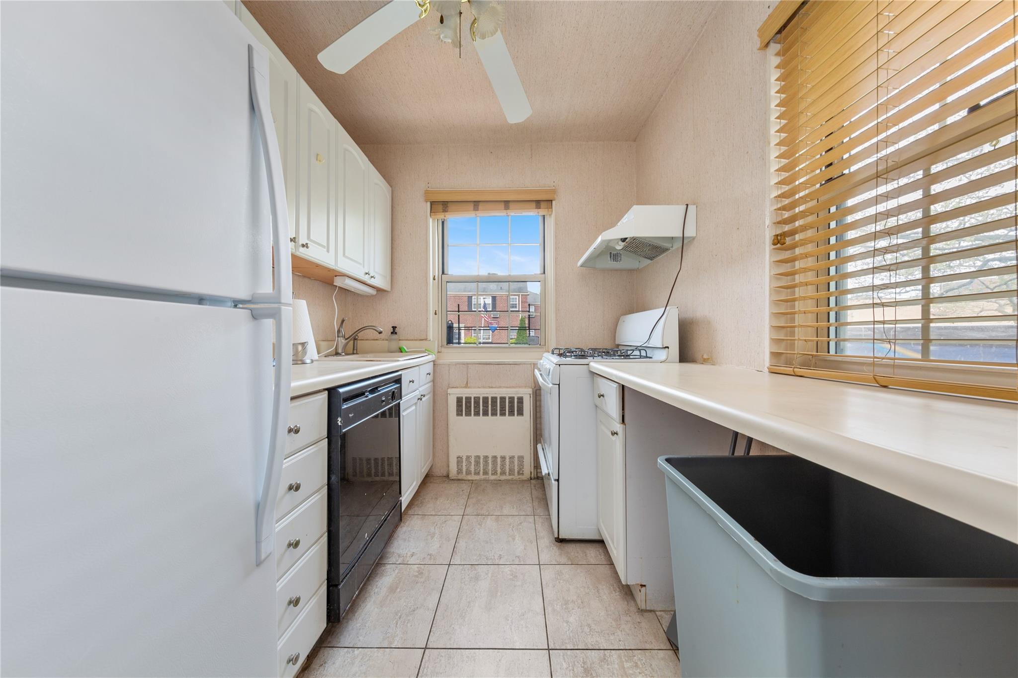 213-15 73rd Avenue, Unit LOWR Queens, NY 11364 - Photo 7 of 13 a kitchen with a cabinets and white appliances