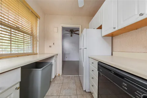 a kitchen with a sink and refrigerator
