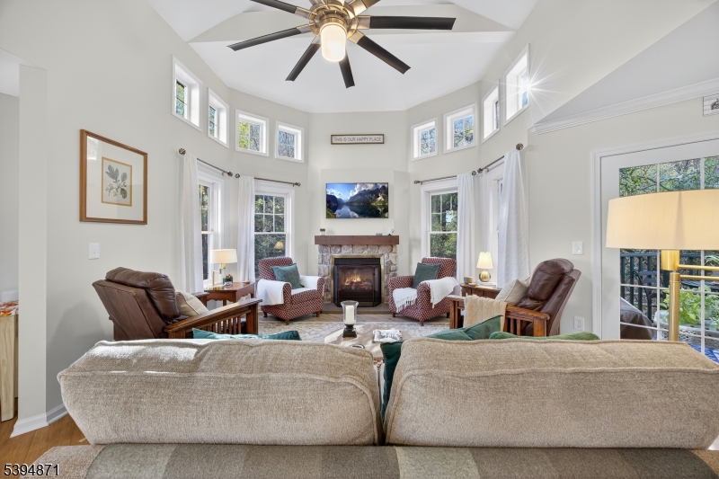10-11 Pine Crescent, Unit 21 Vernon, NJ 07462 - Photo 11 of 50 a living room with furniture a fireplace and a large window