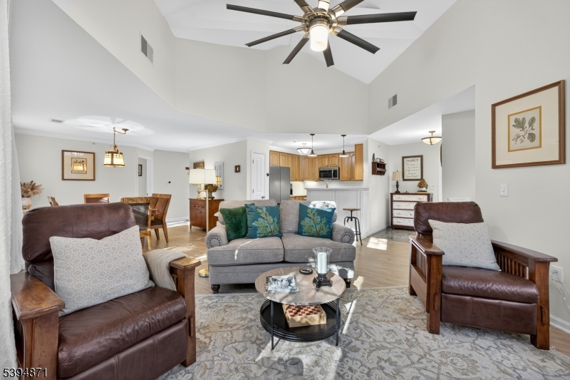 10-11 Pine Crescent, Unit 21 Vernon, NJ 07462 - Photo 12 of 50 a living room with furniture kitchen view and a chandelier