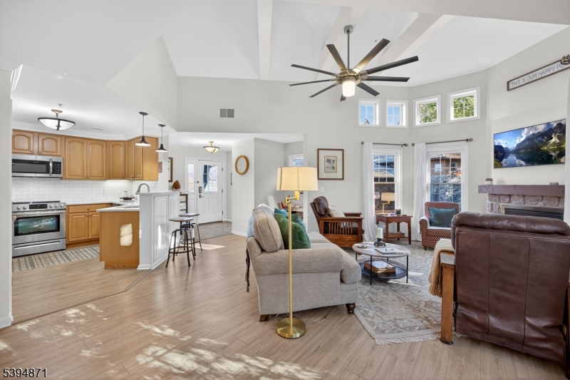 10-11 Pine Crescent, Unit 21 Vernon, NJ 07462 - Photo 14 of 50 a living room with furniture kitchen view and a chandelier