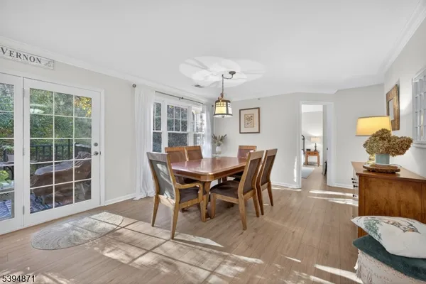 a view of a dining room with furniture and chandelier