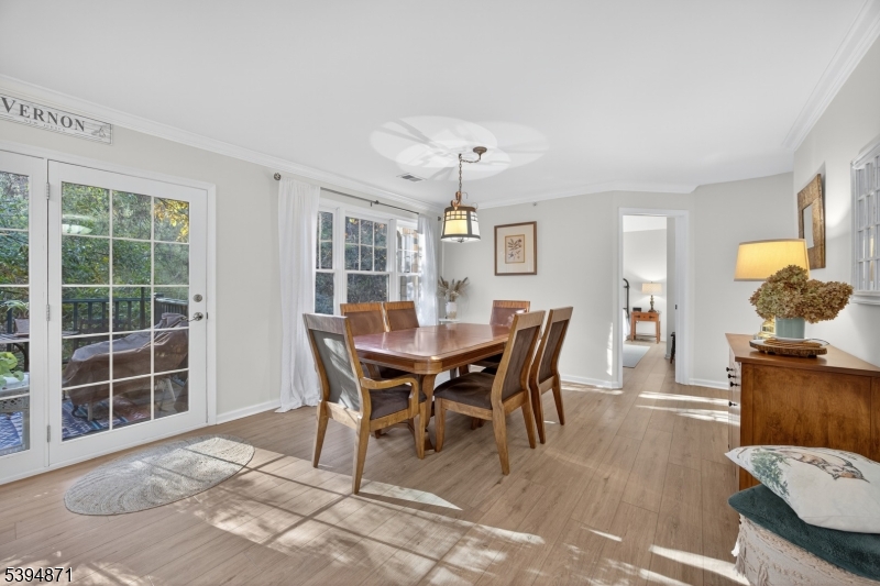 10-11 Pine Crescent, Unit 21 Vernon, NJ 07462 - Photo 17 of 50 a view of a dining room with furniture and chandelier
