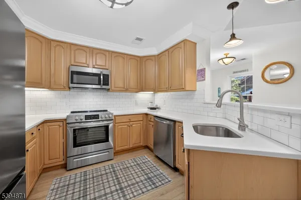 a kitchen with granite countertop a sink a stove and oven