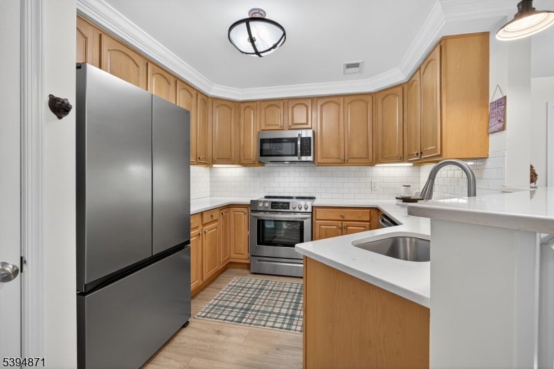 10-11 Pine Crescent, Unit 21 Vernon, NJ 07462 - Photo 22 of 50 a kitchen with a refrigerator sink and stove