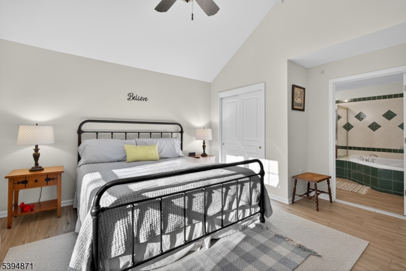 10-11 Pine Crescent, Unit 21 Vernon, NJ 07462 - Photo 24 of 50 a bedroom with a bed a table and painting