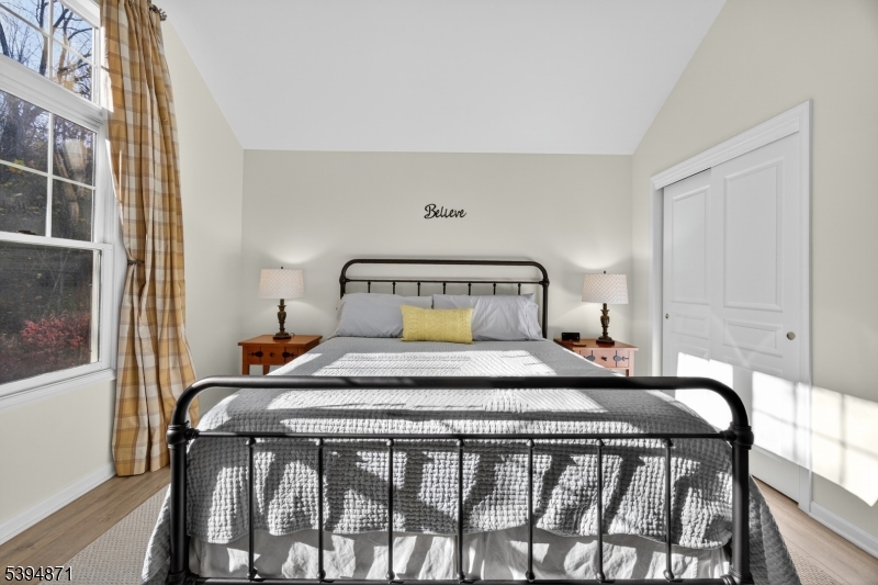 10-11 Pine Crescent, Unit 21 Vernon, NJ 07462 - Photo 25 of 50 a bedroom with a bed and wooden floor