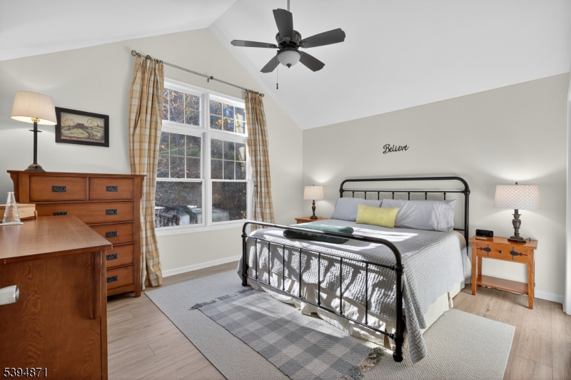 10-11 Pine Crescent, Unit 21 Vernon, NJ 07462 - Photo 26 of 50 a bedroom with a bed and a chandelier