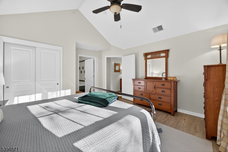 10-11 Pine Crescent, Unit 21 Vernon, NJ 07462 - Photo 27 of 50 a bedroom with a bed and wooden floor