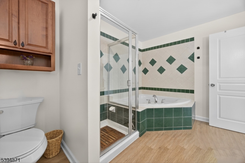 10-11 Pine Crescent, Unit 21 Vernon, NJ 07462 - Photo 30 of 50 a bathroom with a toilet and a shower