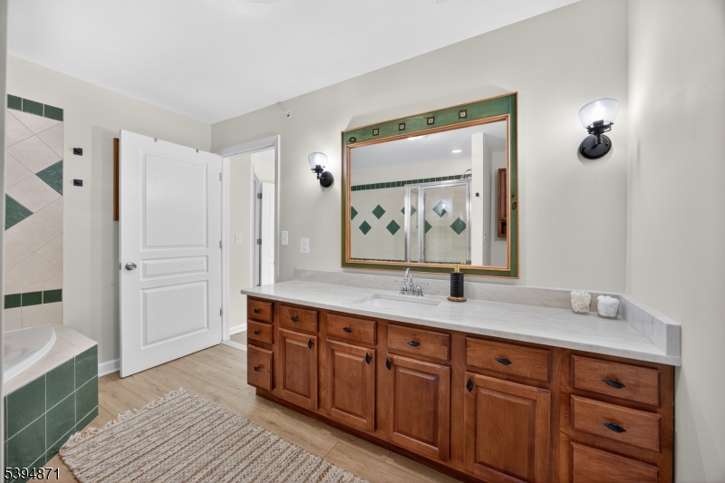 10-11 Pine Crescent, Unit 21 Vernon, NJ 07462 - Photo 31 of 50 a bathroom with a granite countertop sink mirror and