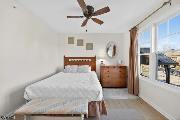 a bedroom with a bed and dresser with mirror